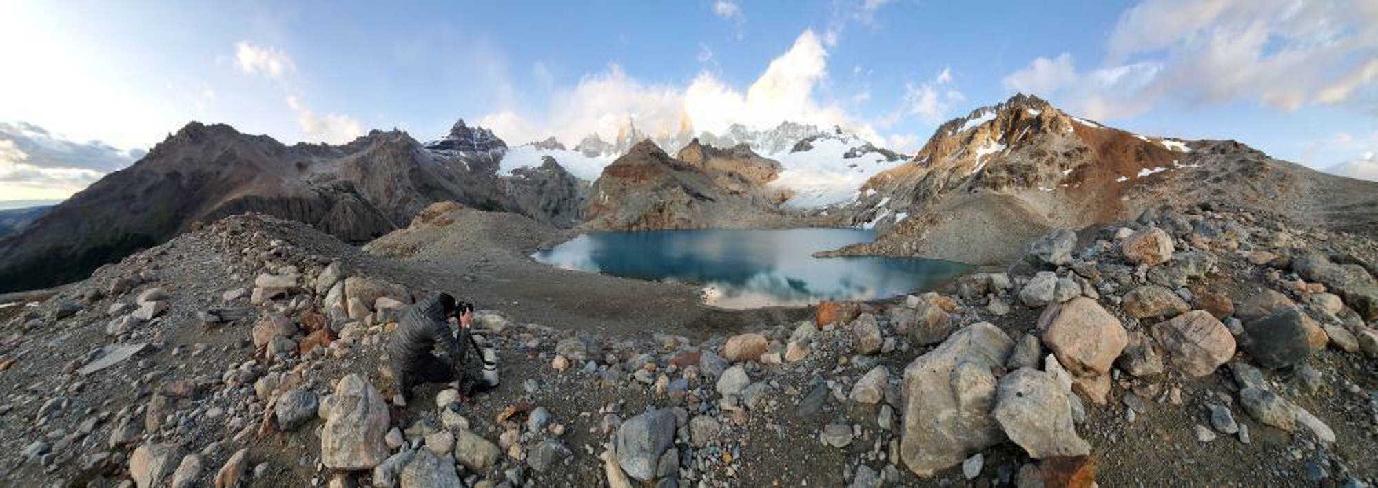 Photo of a photographer on top of a mountain capturing photographic art as a way for him to decompress and relax