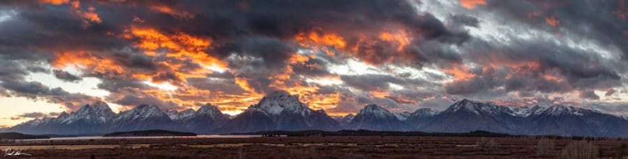 panoramic image of Teton range at sunset with dramatic sky